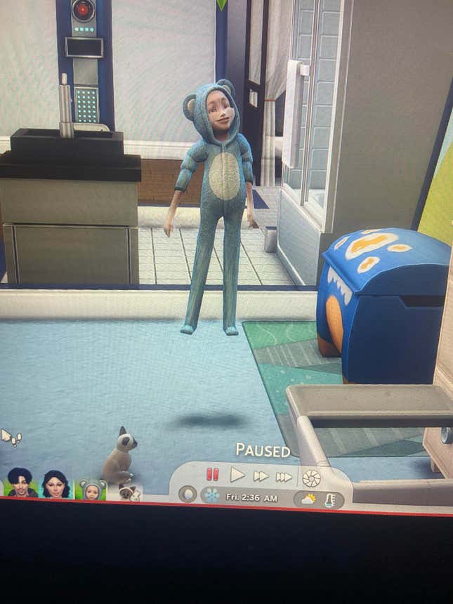 A Sims 4 baby is seen with unusually long legs and is floating in the middle of the room as if possessed by a demon, but is smiling menacingly.