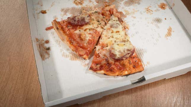 two slices of pizza in delivery box