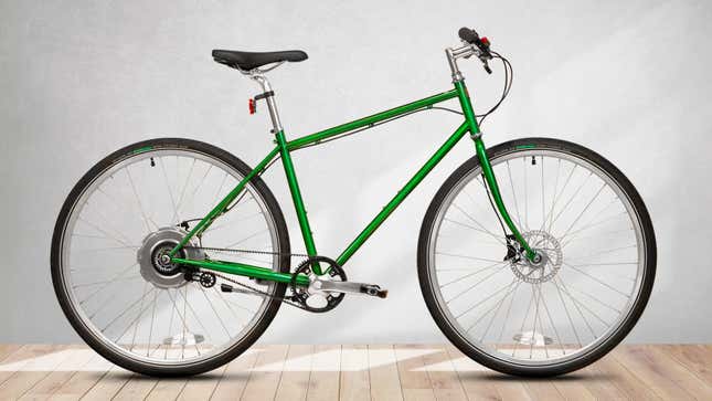 The Detroit Bikes DB-E ebike in an emerald green finish photographed from the side on a wooden floor.