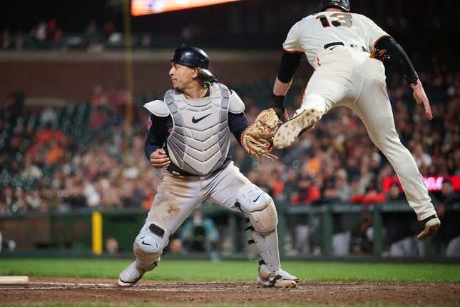 Sep 11, 2023; San Francisco, California, USA; San Francisco Giants outfielder Austin Slater (13) leaps after being tagged out by Cleveland Guardians catcher Bo Naylor (23) on a force play at home plate during the seventh inning at Oracle Park.