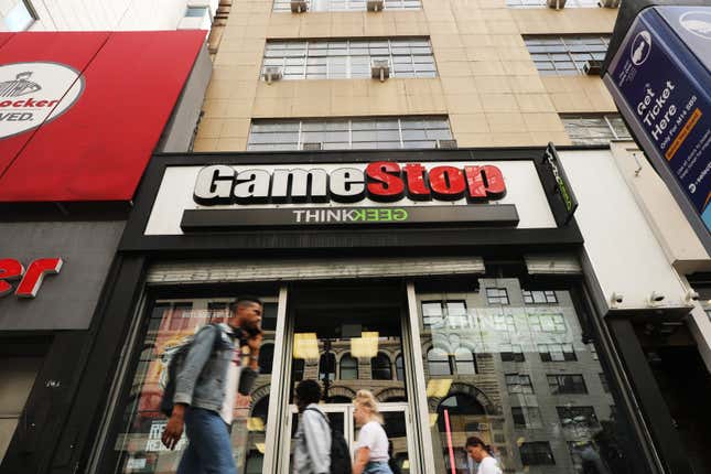 People pass a GameStop store in lower Manhattan.