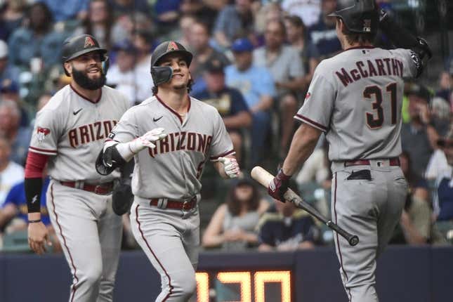 Jun 19, 2023; Milwaukee, Wisconsin, USA; Arizona Diamondbacks center fielder Alek Thomas (5) celebrates with third baseman Emmanuel Rivera (15) and right fielder Jake McCarthy (31) after hitting a two-run home run against the Milwaukee Brewers in the first inning at American Family Field.