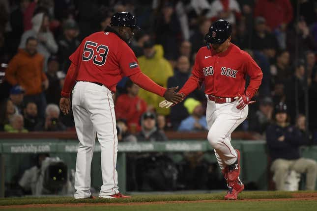 May 2, 2023; Boston, Massachusetts, USA;  Boston Red Sox designated hitter Masataka Yoshida (7) is congratulated by third base coach Carlos Febles (53) after hitting a home run during the fifth inning against the Toronto Blue Jays at Fenway Park.