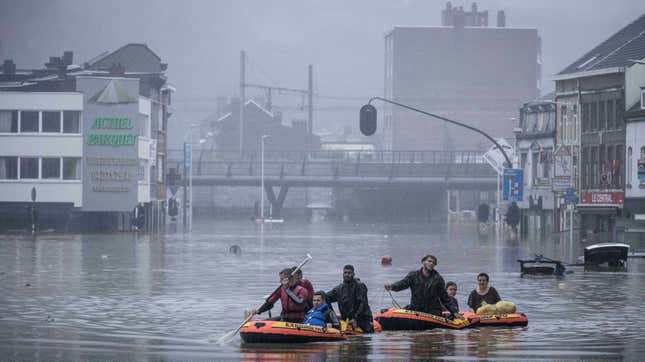 People use rubber rafts in floodwaters after the Meuse River broke its banks during heavy flooding in Liege, Belgium, Thursday, July 15.