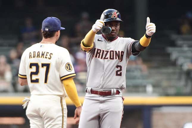Jun 19, 2023; Milwaukee, Wisconsin, USA; Arizona Diamondbacks shortstop Geraldo Perdomo (2) reacts after hitting a double in the first inning as Milwaukee Brewers shortstop Willy Adames (27) looks on at American Family Field.