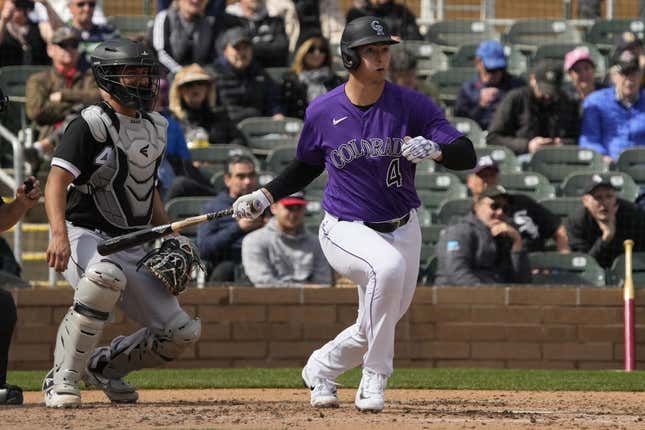 Mar 2, 2023; Salt River Pima-Maricopa, Arizona, USA; Colorado Rockies first baseman Michael Toglia (4) hits an RBI single against the Chicago White Sox in the third inning at Salt River Fields at Talking Stick.