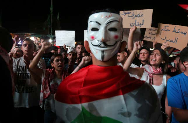 A demonstrator wears a mask during an anti-government protest in the southern city of Nabatiyeh, Lebanon October 22, 2019