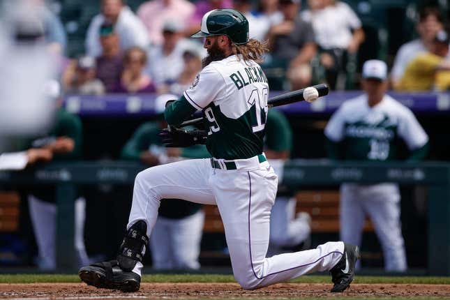 May 17, 2023; Denver, Colorado, USA; Colorado Rockies designated hitter Charlie Blackmon (19) drops to the ground after a foul tip in the fifth inning against the Cincinnati Reds at Coors Field.