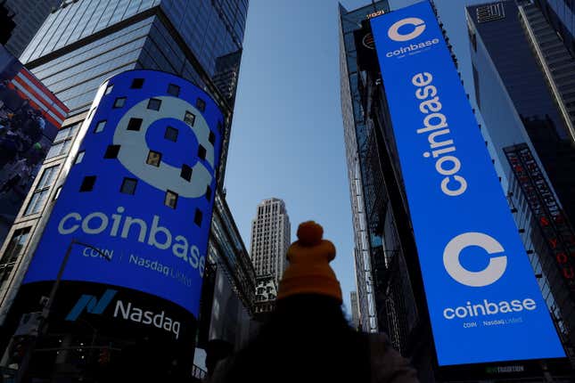 Giant blue ads for Coinbase are lit up on the sides of towering office buildings in New York's Times Square.