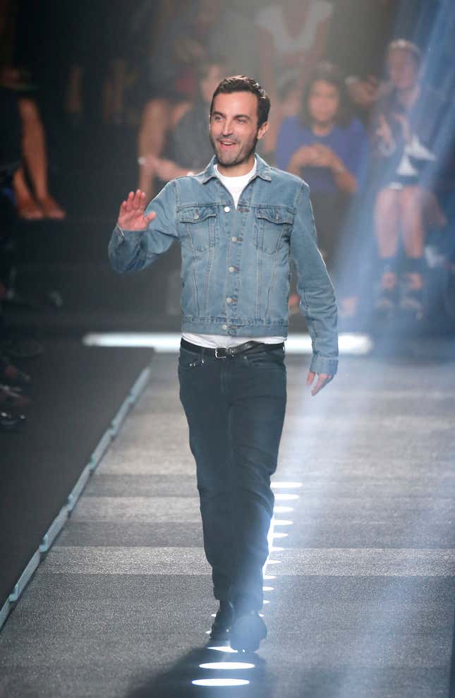 French fashion designer Nicolas Ghesquiere acknowledges applause after the presentation of Louis Vuitton's Spring/Summer 2015 ready-to-wear fashion collection presented in Paris, France, Wednesday, Oct. 1, 2014. (AP Photo/Jacques Brinon)