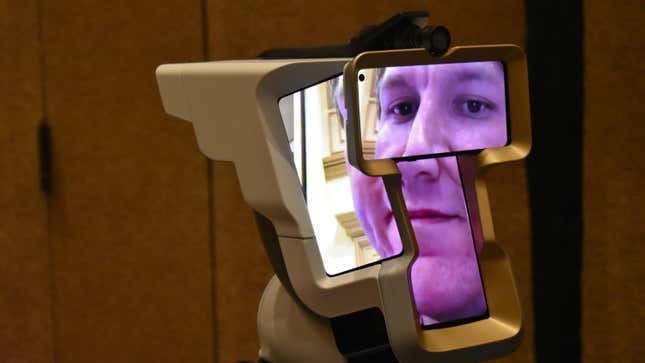 A device with four screens showing multiple parts of a persons' face.