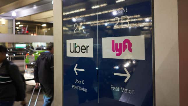 An airport sign directing passengers to the pickup area for Uber and Lyft