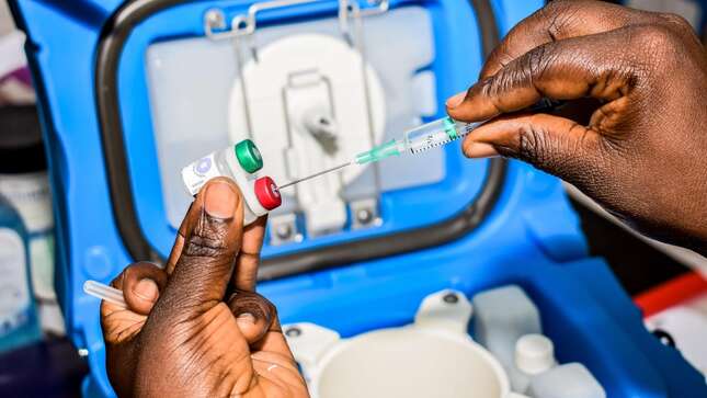 A health worker prepares a dose of the Mosquirix malaria vaccine in Ndhiwa, Homabay County, western Kenya on September 13, 2019.