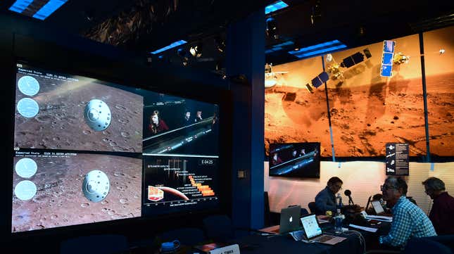 People watch the landing of NASA's InSight spacecraft on the planet Mars on television screens at NASA's Jet Propulsion Laboratory (JPL) in Pasadena, California on November 26, 2018