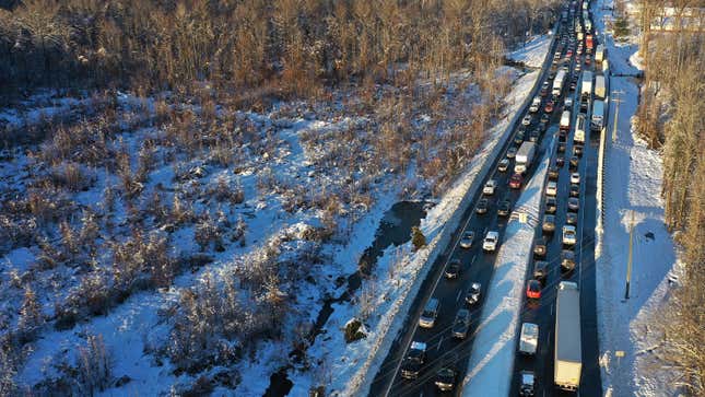Cars backed up on a snow-covered highway 