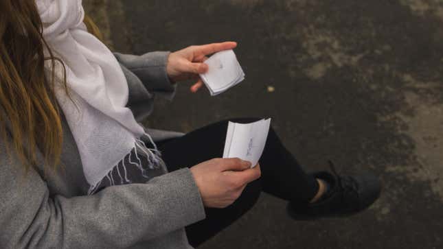 Young woman looking at flashcards 