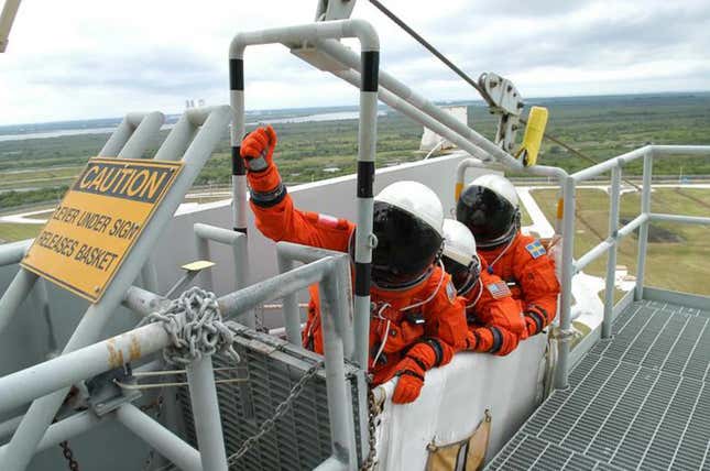 File photo from 2006 showing Space Shuttle astronauts practicing an emergency escape with the egress system on Launch Pad 39B.