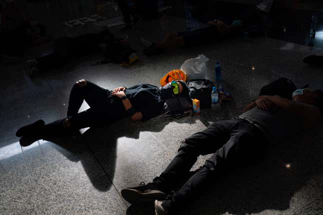 Protesters sleep on the floor at Hong Kong International Airport on Aug. 13, 2019 in Hong Kong.