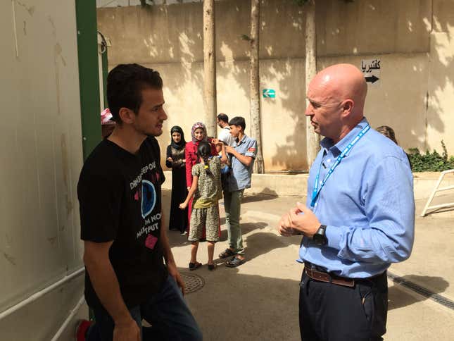 Andrew Harper speaks with a refugee in Jordan.