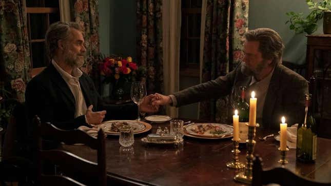 Bill and Frank are shown holding hands at a candle-lit dinner.