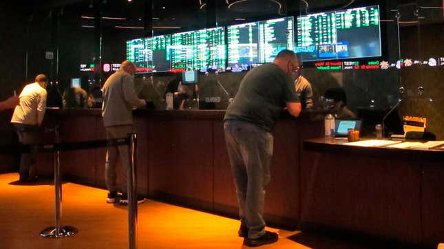 People line up to make sports bets at the Borgata casino in Atlantic City, N.J., March 19, 2021.