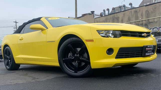 A photo of a yellow Chevrolet Camaro muscle car.