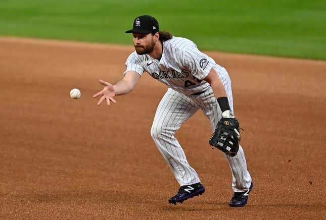 Aug 28, 2020; Denver, Colorado, USA; Colorado Rockies first baseman Daniel Murphy (9) fields the ball in the first inning against the San Diego Padres at Coors Field.