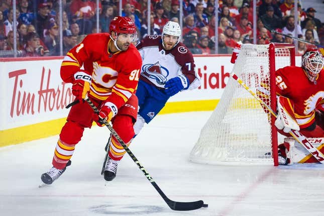 Oct 13, 2022; Calgary, Alberta, CAN; Calgary Flames center Nazem Kadri (91) controls the puck against the Colorado Avalanche during the first period at Scotiabank Saddledome.