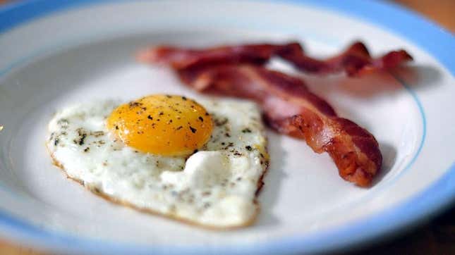 Close-up of eggs and bacon on plate
