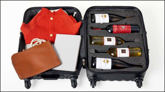 Packed suitcase full of wine bottles