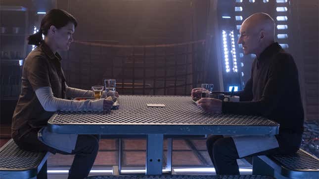 Soji and Picard sit across from each other at a table in a scene from Star Trek series Picard.