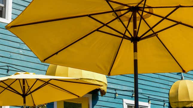 large yellow patio umbrellas in backyard