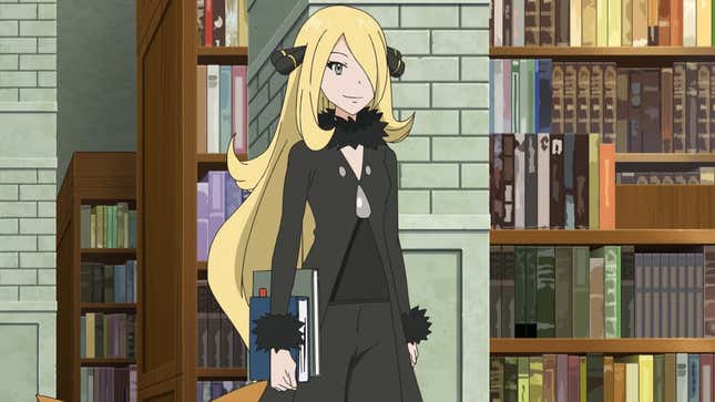 Cynthia is shown holding two books under her arm inside a library.