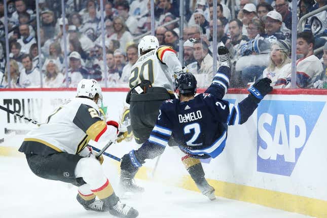 Apr 24, 2023; Winnipeg, Manitoba, CAN; Vegas Golden Knights forward Chandler Stephenson (20) checks Winnipeg Jets defenseman Dylan DeMelo (2) during the first period in game four of the first round of the 2023 Stanley Cup Playoffs at Canada Life Centre.