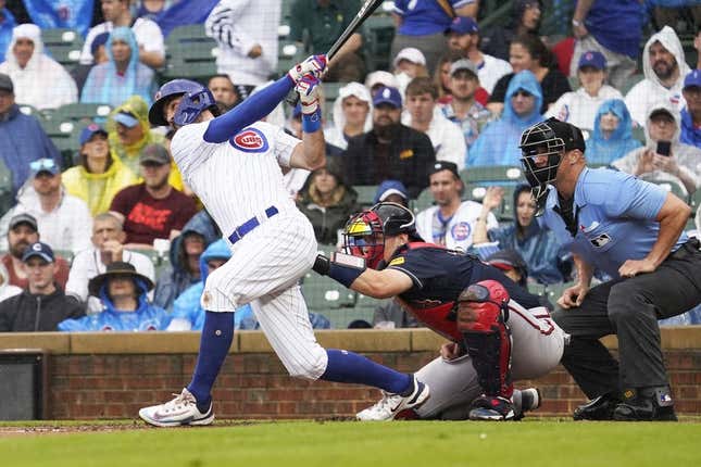 Aug 5, 2023; Chicago, Illinois, USA; Chicago Cubs shortstop Dansby Swanson (7) hits a two-run home run against the Atlanta Braves during the first inning at Wrigley Field.