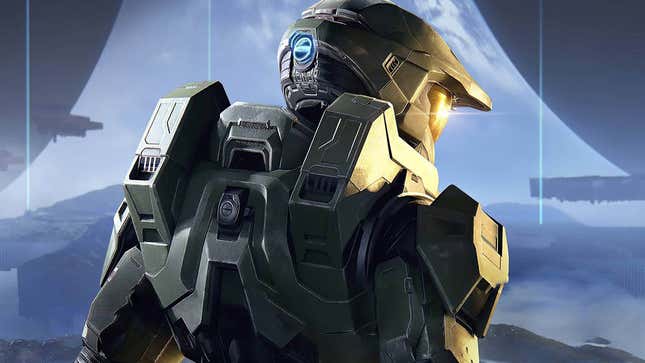 The Master Chief standing alone in front a Halo ring with his back to the viewer. 