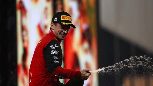 A photo of Charles Leclerc spraying Champagne on the podium. 