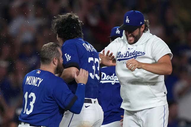 Jul 25, 2023; Los Angeles, California, USA; Los Angeles Dodgers center fielder James Outman (33) celebrates with third baseman Max Muncy (13) and pitcher Clayton Kershaw after hitting a walk-off double in the 10th inning against the Toronto Blue Jays at Dodger Stadium.