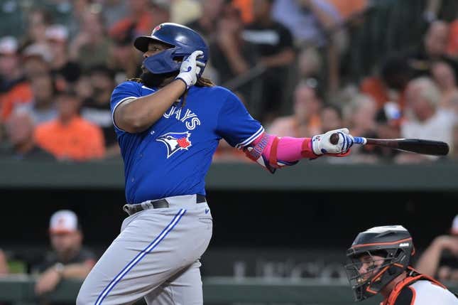 Aug 22, 2023; Baltimore, Maryland, USA;  Toronto Blue Jays first baseman Vladimir Guerrero Jr. (27) singles to center field during the third inning against the Baltimore Orioles at Oriole Park at Camden Yards.