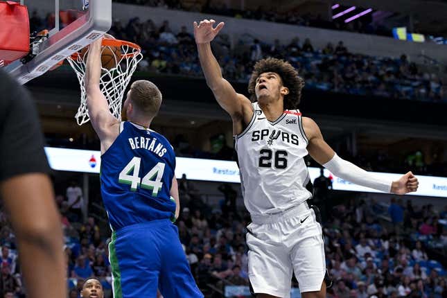Apr 9, 2023; Dallas, Texas, USA; Dallas Mavericks forward Davis Bertans (44) dunks the ball past San Antonio Spurs forward Dominick Barlow (26) during the second quarter at the American Airlines Center.