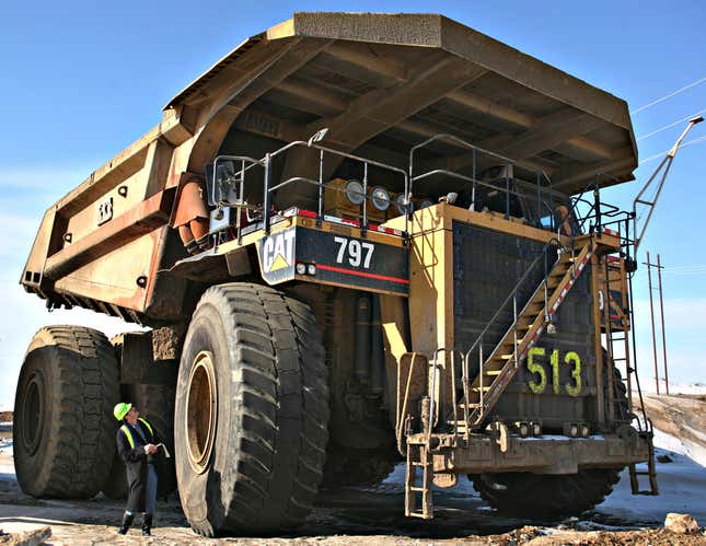 Russell Gold, an energy reporter for the Wall Street Journal, inspects one of Syncrude’s fleet of Caterpillar 797 dump trucks Monday, March 8, 2006 in Fort McMurray, Alberta, Canada. 