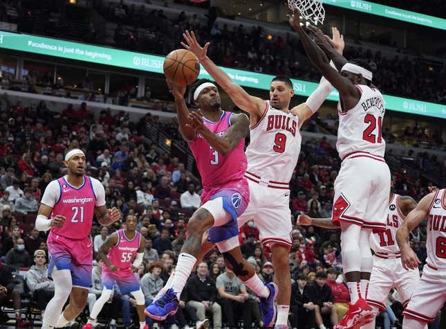 Feb 26, 2023; Chicago, Illinois, USA; Chicago Bulls guard Patrick Beverly (21) and center Nikola Vucevic (9) defend Washington Wizards guard Bradley Beal (3) during the first half at United Center.