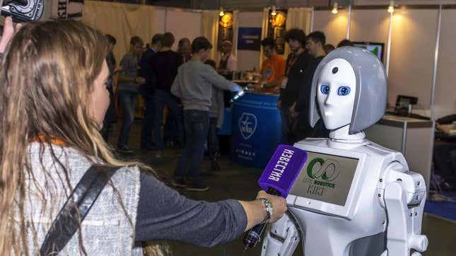 A human journalist interviews a robot at the Moscow Robotics Expo in 2017.