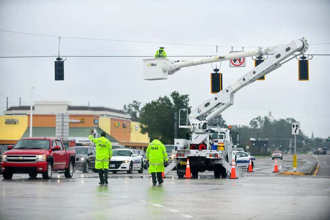 Police officers direct the traffic during a power outage after Hurricane Ian passed through the central Florida on September 29, 2022 in Bartow, Florida. 