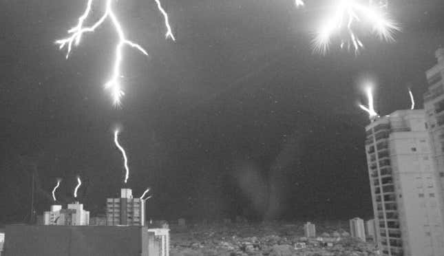 Lightning bolts reaching downwards towards lightning rods in São José dos Campos, Brazil.