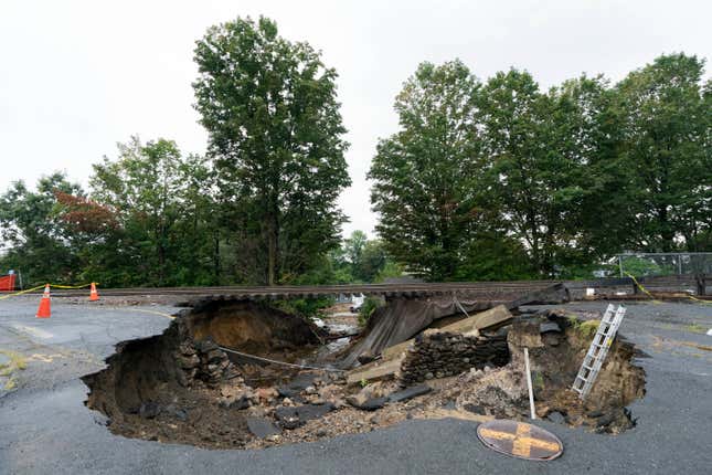 Train tracks on the Fitchburg Line extend over an area washed out by recent flooding on September 13, 2023, in Leominster, Massachusetts. 