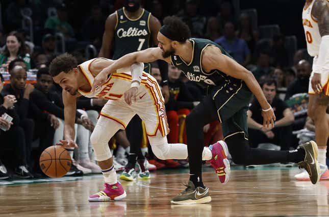 Apr 25, 2023; Boston, Massachusetts, USA; Atlanta Hawks guard Trae Young (11) gathers in a loose ball next to Boston Celtics guard Derrick White (9) during the third quarter of game five of the 2023 NBA playoffs at TD Garden.