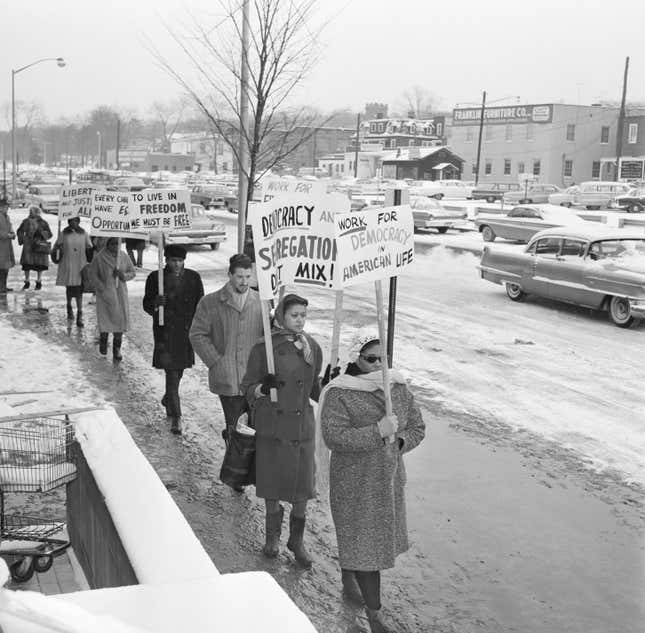 Englewood, NJ: Protest segregated schools: Pickets in front of the Municipal Building here February 2nd, to protest the arrest of 11 persons during sit-in demonstrations protesting allegedly segregated school. The sit-in took place Feb.1 and Feb 2. at City Hall in protest to a Board of education ruling barring nine Negro children from predominantly white Quarles School Feb 1., because of a zoning restriction. 