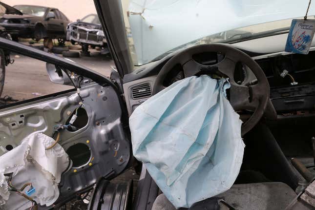 A deployed airbag is seen in a wrecked 2001 Honda Accord.