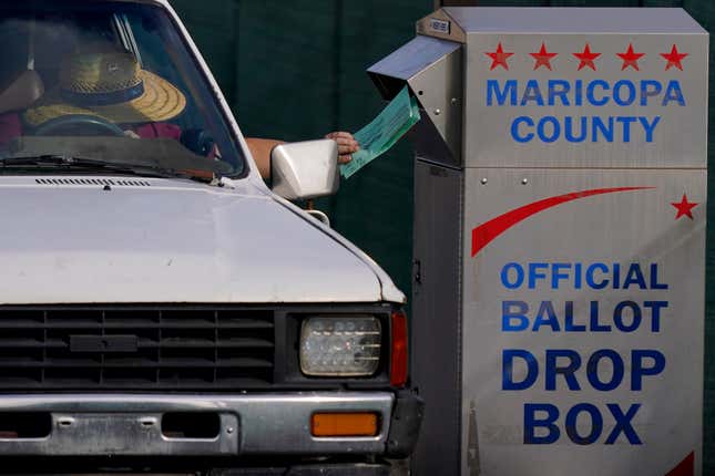 A voter casts their ballot at a secure ballot drop box at the Maricopa County Tabulation and Election Center in Phoenix, Tuesday, Nov. 1, 2022.